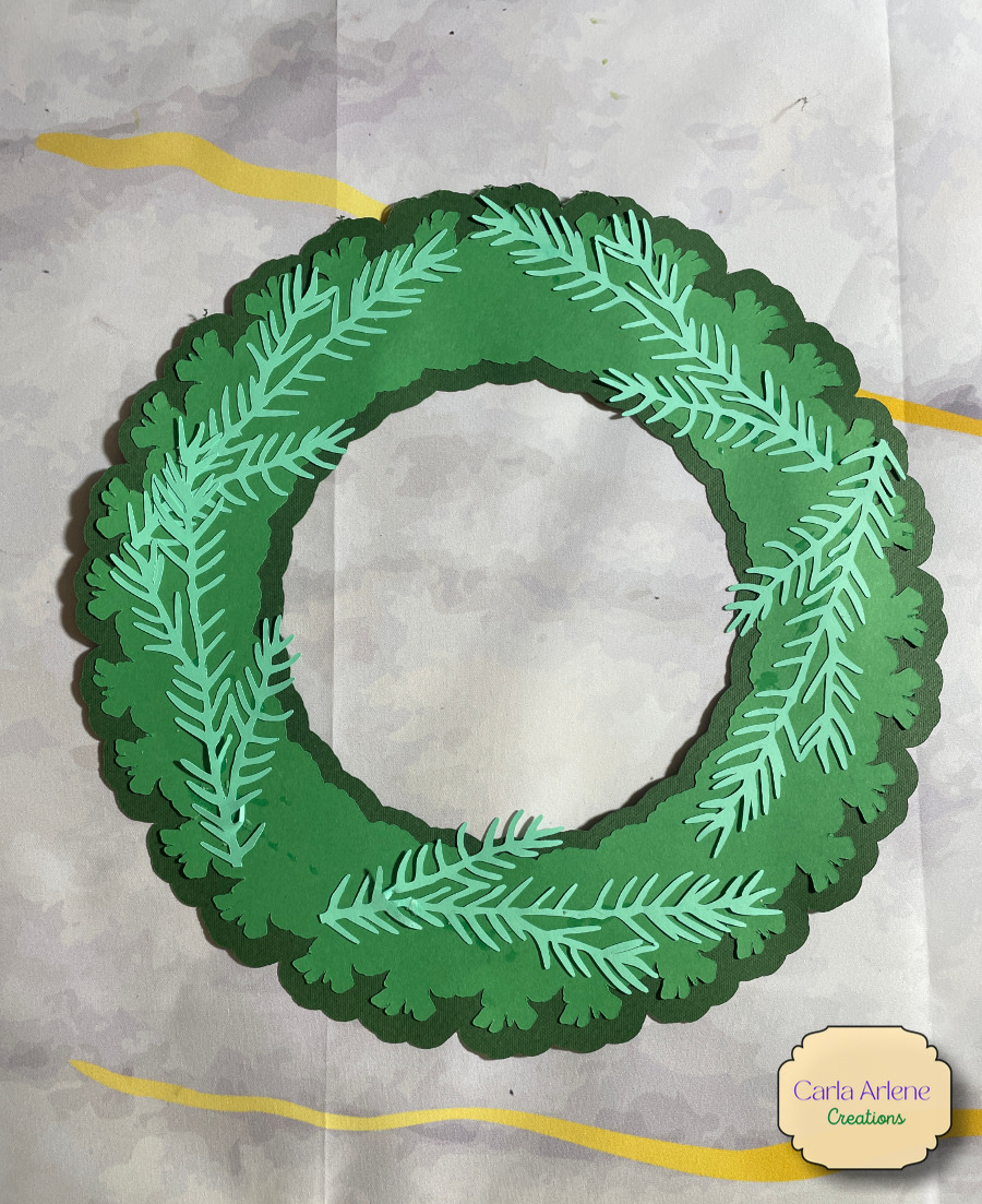 pinecone wreath with pine needles on it